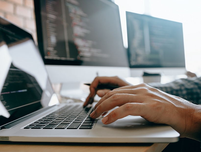 hands on keyboard of laptop