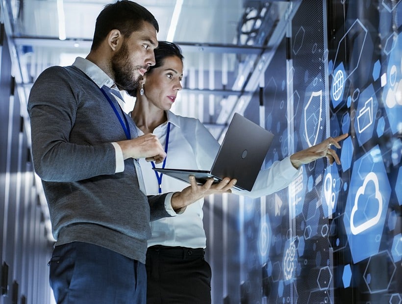 two workers looking at servers