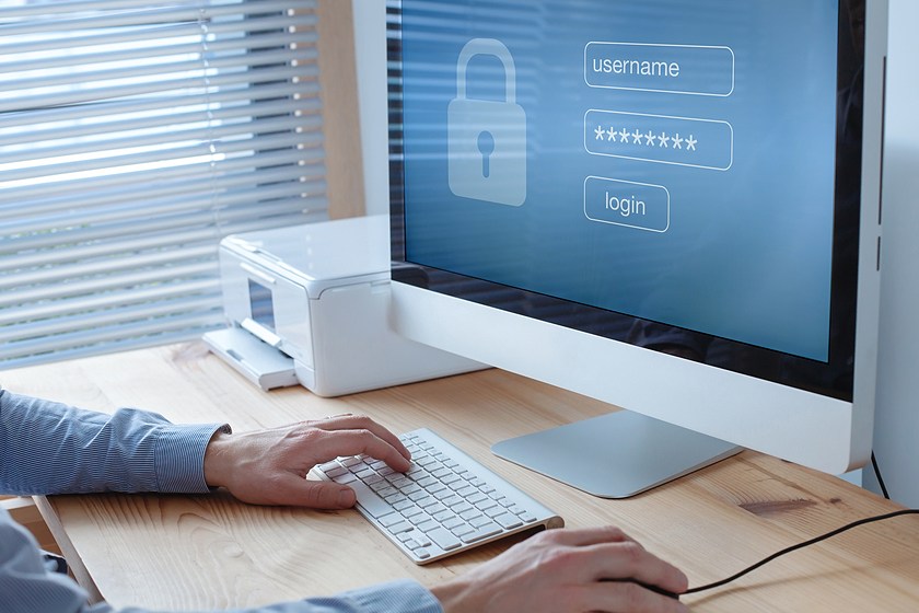 man logging into secure computer
