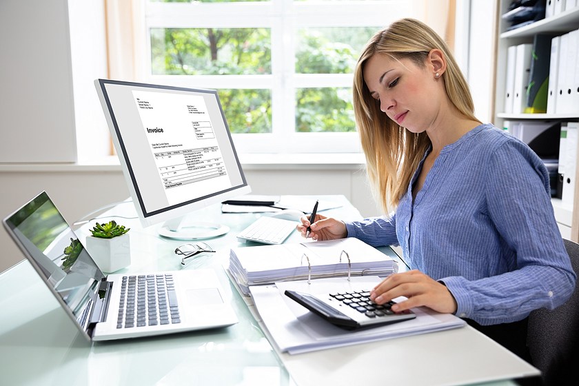 woman using computer and calculator